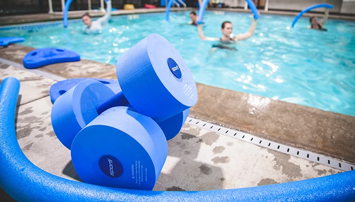 Blue foam water dumbbells at poolside