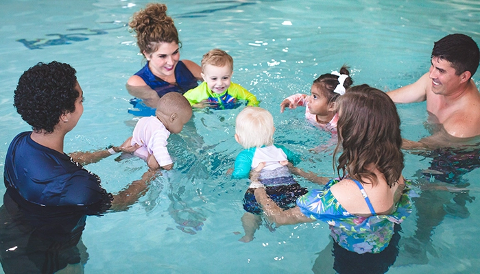 Parents and babies in a pool swim lesson