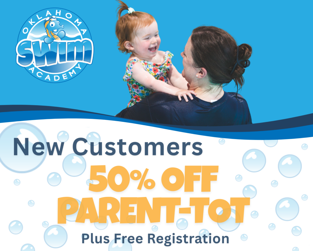 Parent holding toddler smiling in swim class